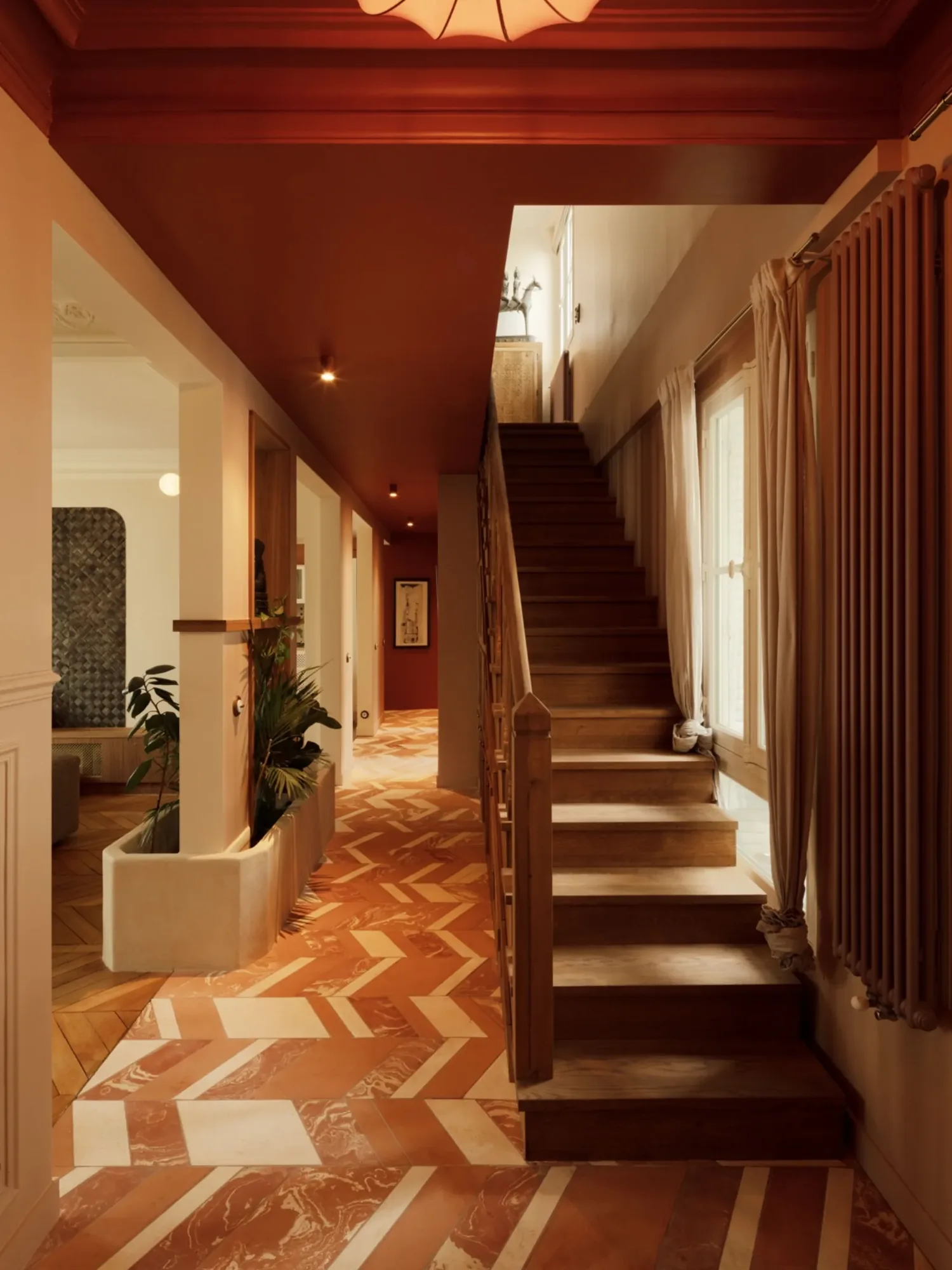 Projet Vavin, Paris 6e — entrée du duplex de 220 m², plafond rouge, escalier et sol en terre cuite, architecte d'intérieur Paris — Studio Emsé